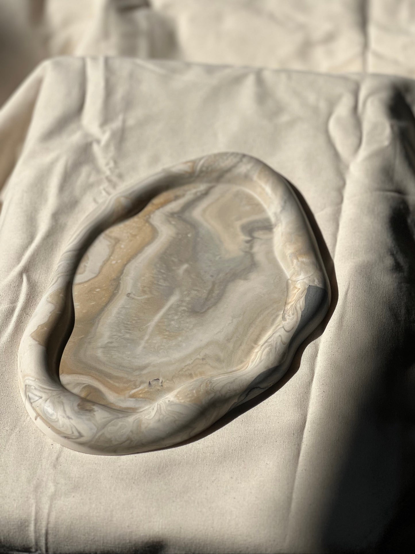 Close-up of a stone with concentric circles on a textured surface